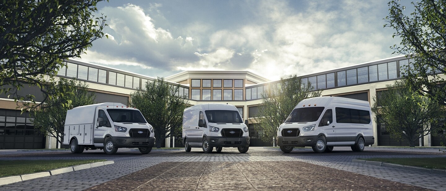 A 2023 Ford Transit® Cutaway Van, 2023 Ford Transit® Cargo Van and 2023 Ford Transit® Passenger Van in front of a building