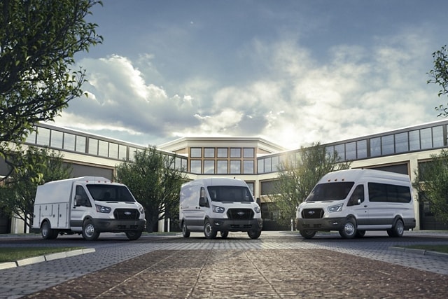 A 2023 Ford Transit® Cutaway Van, 2023 Ford Transit® Cargo Van and 2023 Ford Transit® Passenger Van in front of a building
