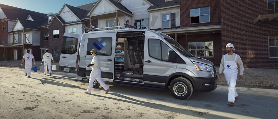 A work crew walking away from a 2023 Ford Transit® Van at a construction site