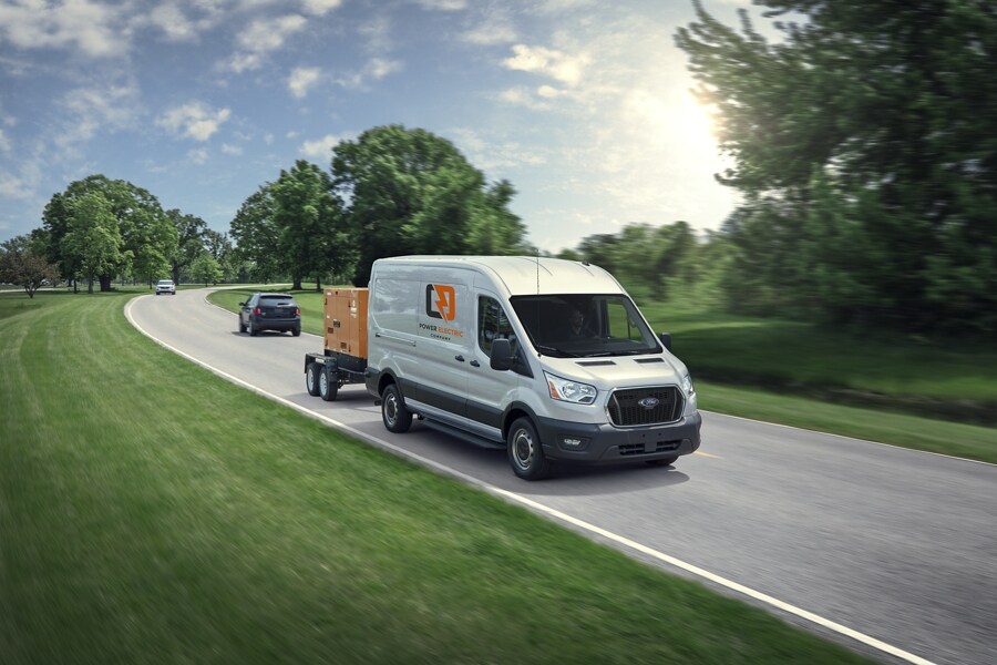A 2023 Ford Transit® Van towing a trailer