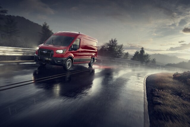 A 2023 Ford Transit® Van being driven on a wet road