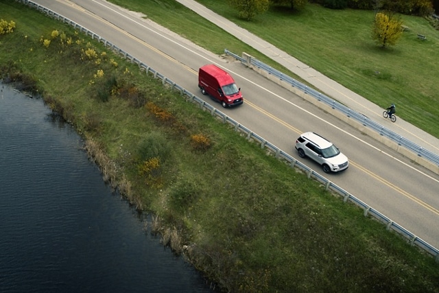 Birds-eye view of a 2024 Ford Transit® van being driven on a highway