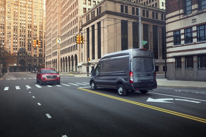 A 2024 Ford Transit® van being driven down a city street