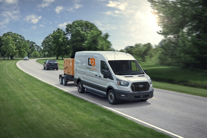 A 2024 Ford Transit® van towing a huge power generator