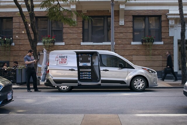 2023 Ford Transit Connect Cargo Van parked in the city shown with available rear swing cargo doors