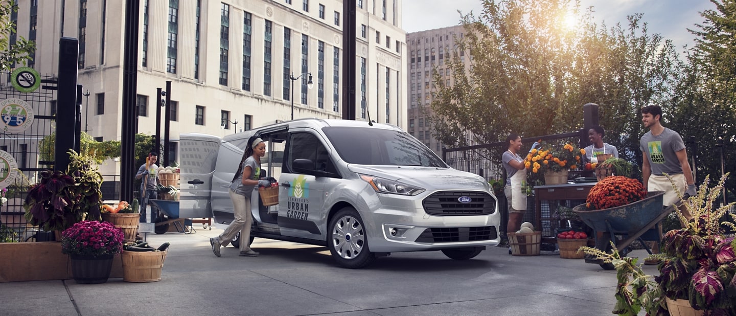 People at a flower market putting the 2023 Ford Transit Connect Cargo Van to work