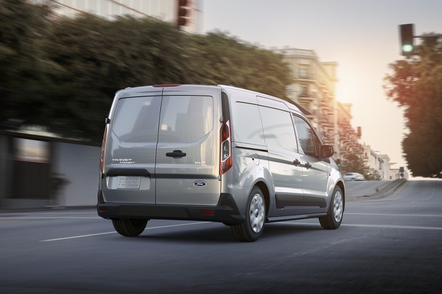 2023 Ford Transit Connect Cargo Van in Silver on city street shown with available swing-out rear cargo doors