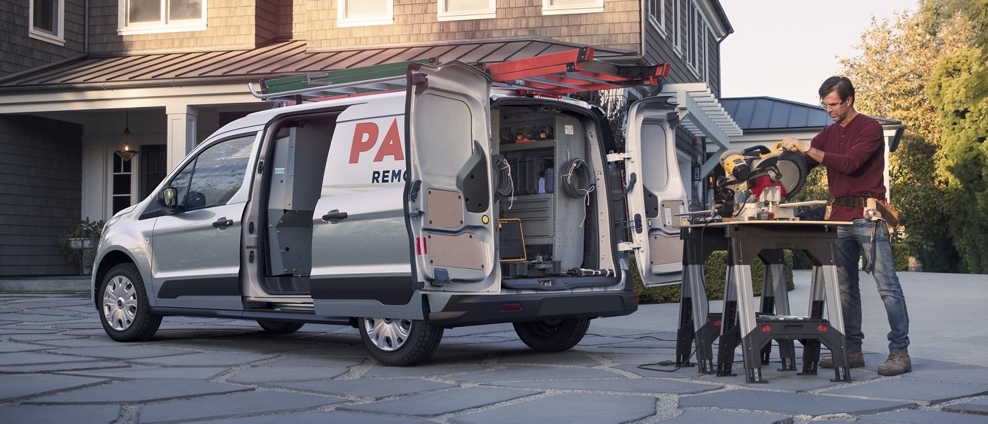 2023 Ford Transit Connect Cargo Van in Silver shown with a tradesman working in front of a house