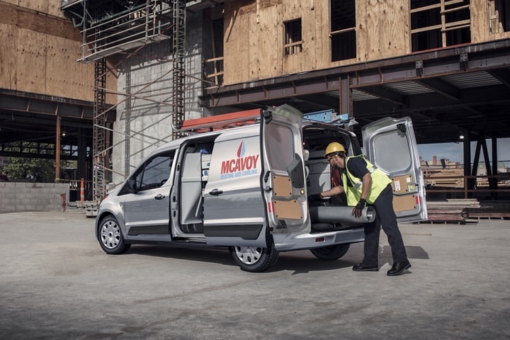 Worker on job site with 2023 Ford Transit Connect Cargo Van in Silver