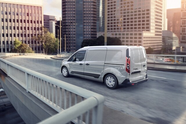 2023 Ford Transit Connect Cargo Van in Silver being driven on a city street