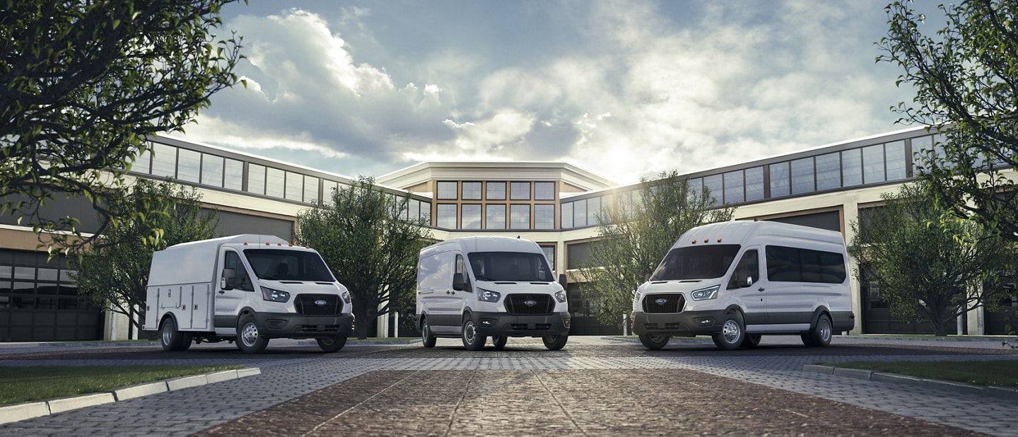 Three 2023 Ford Transit® van vehicles parked in front of a building